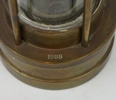 Gruvlykta, mässing/glas, E. Thomas & Williams Ltd, Wales, 1988.